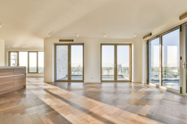 Spacious, sunlit room with large windows showcasing modern window installation in Norwalk for enhanced views and energy efficiency.